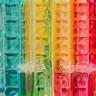 Close-up of colorful soap bars being poured into molds